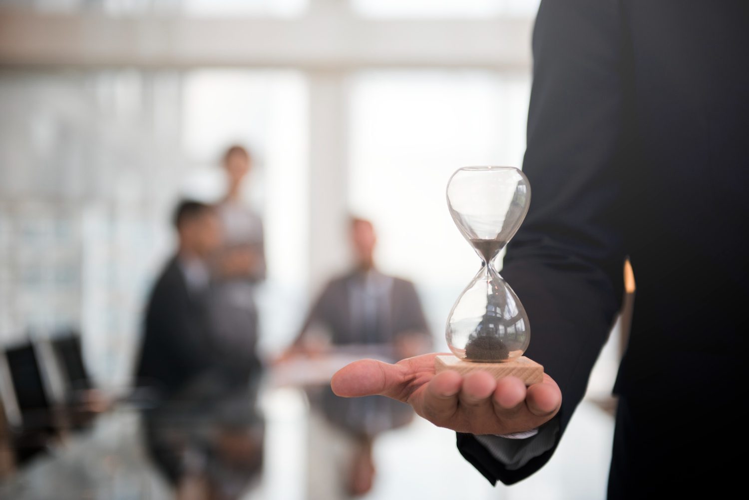 businessman-holding-hour-glass-signifies-importance-being-time businessman holding hour glass signifies importance being time